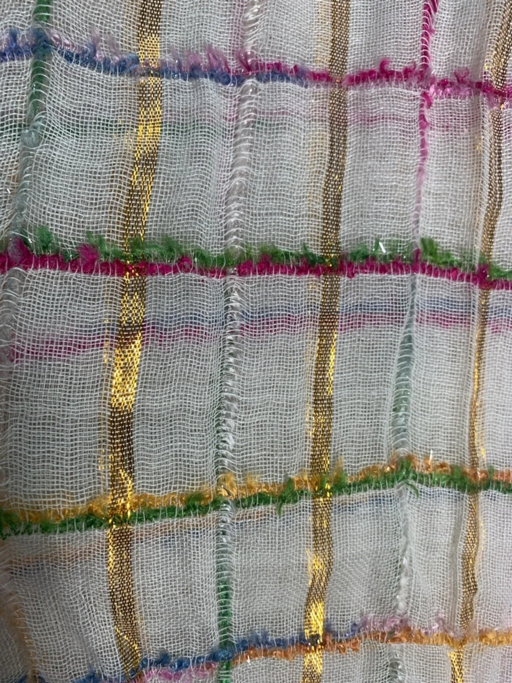 White, metallic gold, pink, blue, and green scarf with fringe